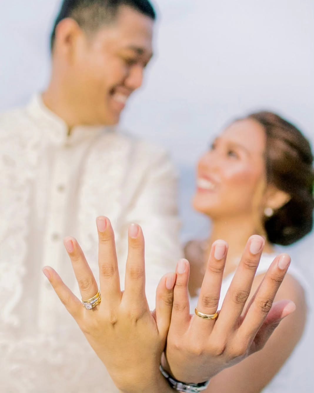 Couple showing off their rings
